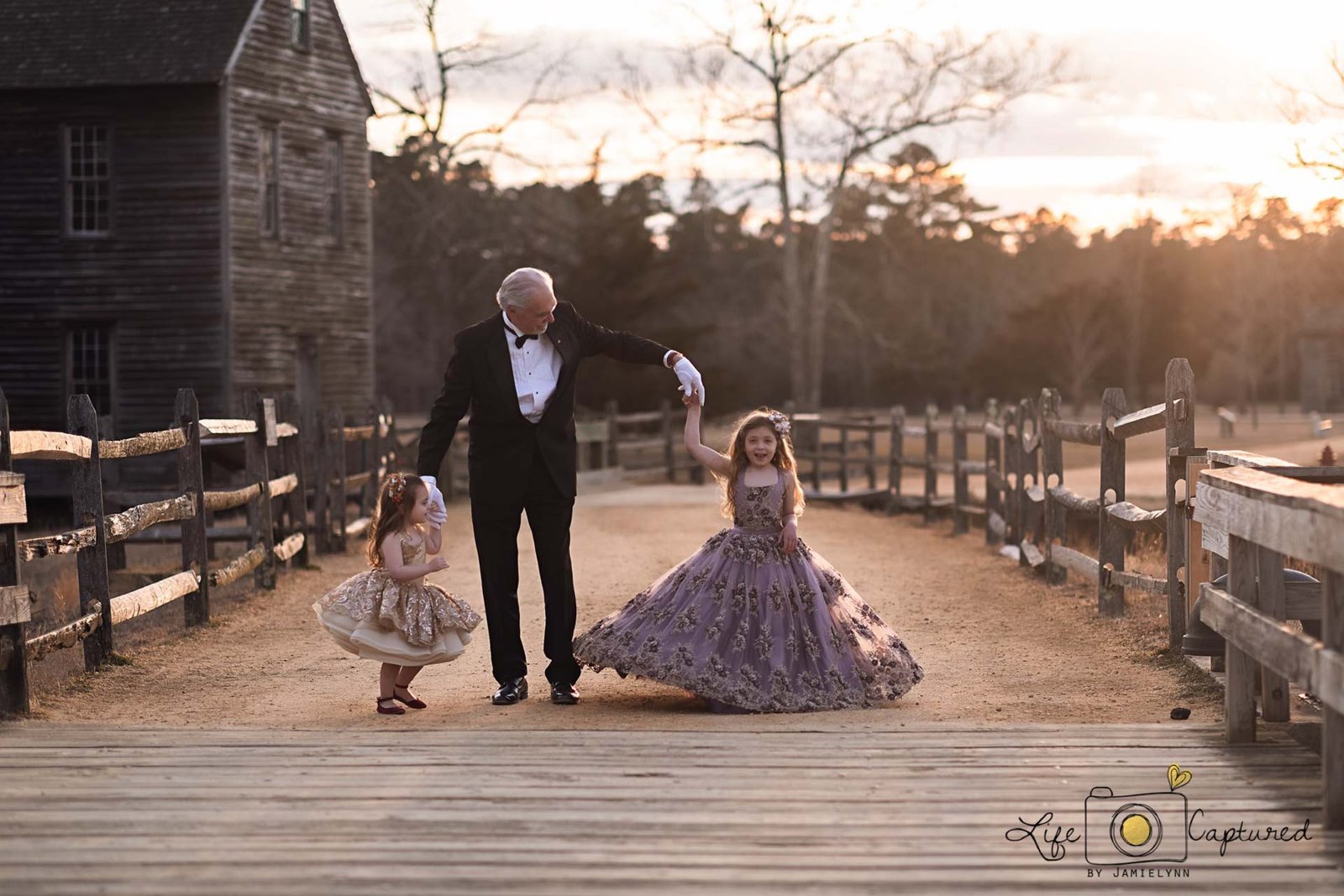 Granddaughters elegantly dressed with grandpa in family portraits