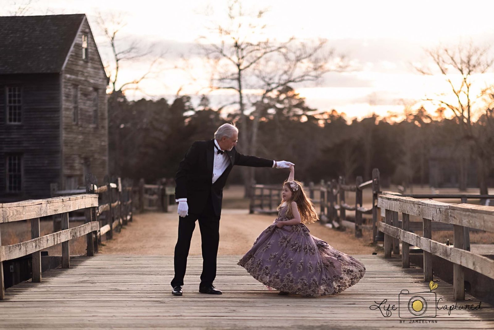 Grandfather twirling his granddaughter during a Medford, NJ family photo shoot